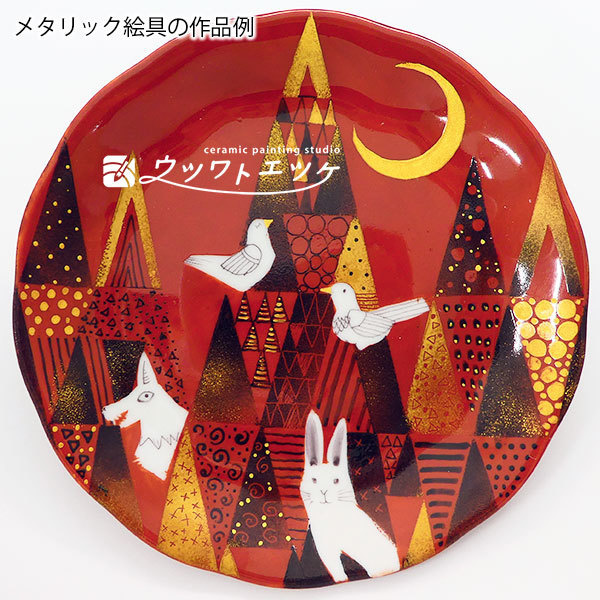 赤とメタリックの絵具で森と動物が描かれた丸皿